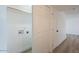 The laundry closet features white walls and a convenient setup at 8802 W Monterey Way, Phoenix, AZ 85037