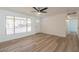 Bright living room boasts modern flooring, white walls, a ceiling fan and natural light at 8802 W Monterey Way, Phoenix, AZ 85037