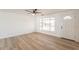Bright, open living room featuring new floors, white walls and ample natural light at 8802 W Monterey Way, Phoenix, AZ 85037