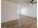 Bright, spacious living room featuring new floors and white walls at 8802 W Monterey Way, Phoenix, AZ 85037