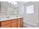 Bathroom featuring double sinks, bathtub and shower with neutral tile floors at 9072 W Myrtle Ave, Glendale, AZ 85305