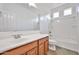 Bright bathroom with a tub and shower combo, vanity, and a sink offers a clean and functional space at 9072 W Myrtle Ave, Glendale, AZ 85305