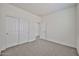 This bedroom features carpet, an open doorway and a sliding closet for easy and ample storage at 9072 W Myrtle Ave, Glendale, AZ 85305
