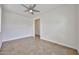 Clean bedroom featuring tile floors, a ceiling fan, and an open doorway for a cool and flowing space at 9072 W Myrtle Ave, Glendale, AZ 85305