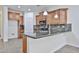 This kitchen features wooden cabinets, tile backsplash, granite countertops and stainless steel appliances at 9072 W Myrtle Ave, Glendale, AZ 85305