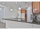 This kitchen features wooden cabinets, tile backsplash, granite countertops and stainless steel appliances at 9072 W Myrtle Ave, Glendale, AZ 85305