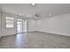 An airy living room boasts neutral tile floors, a ceiling fan, recessed lighting, and access to the outdoor patio at 9072 W Myrtle Ave, Glendale, AZ 85305