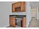 Wet bar featuring granite counters, wine refrigerator, and stylish wood cabinetry at 9072 W Myrtle Ave, Glendale, AZ 85305