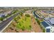 Expansive aerial view of a community featuring open green spaces, nearby roads and multiple residential homes at 9157 W Country Club Trl, Peoria, AZ 85383