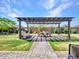 Inviting backyard with a cozy pergola-covered dining area and a built-in grill for outdoor gatherings at 9157 W Country Club Trl, Peoria, AZ 85383
