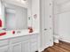 Bright bathroom featuring a white vanity, a large mirror, and a separate toilet room at 9157 W Country Club Trl, Peoria, AZ 85383