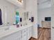 Bathroom with dual sinks, ample counter space and a view to the bedroom at 9157 W Country Club Trl, Peoria, AZ 85383