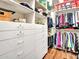 Walk in closet with custom built-in shelves and drawers for storage at 9157 W Country Club Trl, Peoria, AZ 85383