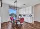 Dining room features wood floors, a decorative light fixture, and built in cabinets at 9157 W Country Club Trl, Peoria, AZ 85383