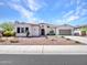 Charming single-story home boasting a tile roof, an arched entryway, and a well-maintained desert-style front yard at 9157 W Country Club Trl, Peoria, AZ 85383