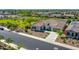 Aerial view of a well-manicured home featuring a tile roof, low-maintenance landscaping, and a spacious three-car driveway at 9157 W Country Club Trl, Peoria, AZ 85383