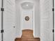 Hallway features wood floors and white doors leading to other rooms in the house at 9157 W Country Club Trl, Peoria, AZ 85383