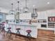 Bright, modern kitchen with white cabinetry, a large island, and stainless steel appliances at 9157 W Country Club Trl, Peoria, AZ 85383