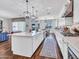 Open concept kitchen with island seating and stainless steel appliances at 9157 W Country Club Trl, Peoria, AZ 85383