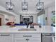 Modern kitchen features a large island with a stainless steel sink and views of the living room at 9157 W Country Club Trl, Peoria, AZ 85383
