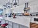Spacious kitchen with a large island, stylish lighting, and stainless steel appliances at 9157 W Country Club Trl, Peoria, AZ 85383