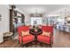 Open living space with hardwood floors, built-in shelving, and coordinated furnishings at 9157 W Country Club Trl, Peoria, AZ 85383