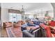 Open-concept living room with plush seating, decorative rug, and view into the adjacent kitchen at 9157 W Country Club Trl, Peoria, AZ 85383