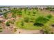 Community park with winding walking paths, lush green spaces, mature trees, and inviting landscaping for outdoor activities at 9157 W Country Club Trl, Peoria, AZ 85383