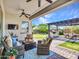 Inviting covered patio with comfortable seating and an outdoor kitchen area at 9157 W Country Club Trl, Peoria, AZ 85383