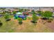 Community playground with colorful play structures, mature trees, and open green space for recreation and enjoyment at 9157 W Country Club Trl, Peoria, AZ 85383