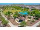 Community playground with a picnic area shaded by blue canopies, featuring modern play structures and walking paths at 9157 W Country Club Trl, Peoria, AZ 85383