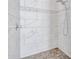 Shower features white tile and decorative mosaic accents at 9157 W Country Club Trl, Peoria, AZ 85383