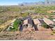 Beautiful aerial view of single-story home with desert landscaping, mountain views, and convenient access to surrounding community at 10109 E Trailhead Ct, Gold Canyon, AZ 85118