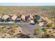 High aerial view of homes in a desert community, showcasing the tranquil environment with well-maintained desert landscaping at 10109 E Trailhead Ct, Gold Canyon, AZ 85118