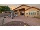 Beautiful outdoor patio with desert landscaping, brick pavers, and a cozy seating area perfect for entertaining at 10109 E Trailhead Ct, Gold Canyon, AZ 85118