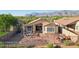 Private backyard with a covered patio, desert landscaping, mountain views, and ample space for outdoor entertaining at 10109 E Trailhead Ct, Gold Canyon, AZ 85118