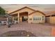 Charming backyard with a spacious brick patio, a covered patio, and a decorative pergola at 10109 E Trailhead Ct, Gold Canyon, AZ 85118