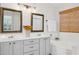 Well-lit bathroom featuring double sinks, framed mirrors, and a soaking tub at 10109 E Trailhead Ct, Gold Canyon, AZ 85118