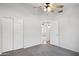 Clean and neutral-toned bedroom with large closet, ceiling fan, and connecting doorway at 10109 E Trailhead Ct, Gold Canyon, AZ 85118