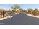 Gated entrance to the community with stone pillars and well-maintained landscaping at 10109 E Trailhead Ct, Gold Canyon, AZ 85118