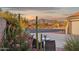 Inviting exterior view showcasing desert landscaping, colorful flowering shrubs, and peaceful mountain views at 10109 E Trailhead Ct, Gold Canyon, AZ 85118