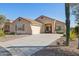 Inviting front exterior with desert landscaping, a spacious driveway, and neutral color scheme at 10109 E Trailhead Ct, Gold Canyon, AZ 85118