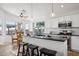 Open kitchen featuring a breakfast bar, sleek countertops, stainless appliances and a ceiling fan at 10109 E Trailhead Ct, Gold Canyon, AZ 85118