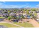 Neighborhood aerial with homes featuring private pools and lush green spaces, set against a scenic mountain backdrop at 10305 E Plata Ave, Mesa, AZ 85212