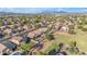 Beautiful aerial shot of a residential area featuring mature trees, green lawns, and mountain views at 10305 E Plata Ave, Mesa, AZ 85212
