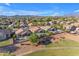 Scenic aerial view of a suburban neighborhood with pools and mountain views in the background at 10305 E Plata Ave, Mesa, AZ 85212