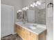 This is a bathroom vanity featuring dual sinks, ample counter space, and an illuminated mirror for enhanced visibility at 10305 E Plata Ave, Mesa, AZ 85212
