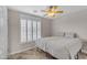 This is a bright bedroom with shuttered windows and a ceiling fan, offering comfort and natural light at 10305 E Plata Ave, Mesa, AZ 85212