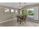 Cozy dining area with neutral walls, natural light, backyard views, and a rustic table, perfect for casual dining at 10305 E Plata Ave, Mesa, AZ 85212