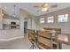 Bright dining area with a rustic wood table and a view into the kitchen, ideal for both casual meals and entertaining at 10305 E Plata Ave, Mesa, AZ 85212